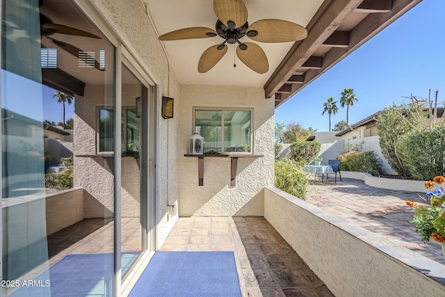 balcony with a patio and ceiling fan