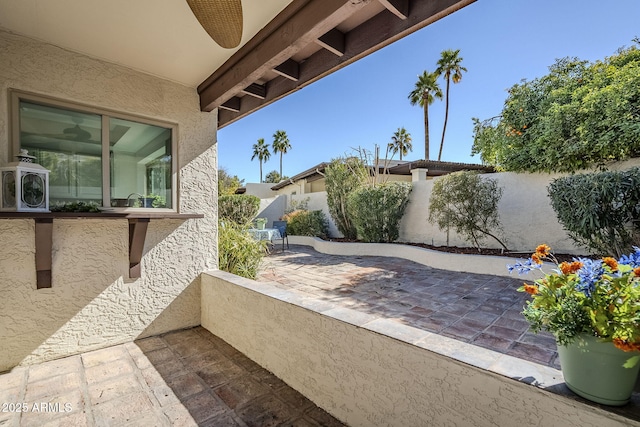 view of patio featuring ceiling fan