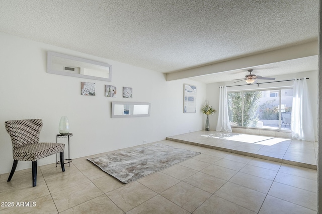 interior space featuring light tile patterned floors, a textured ceiling, and ceiling fan