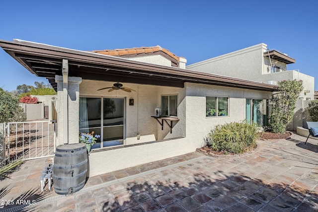 back of house with a patio and ceiling fan