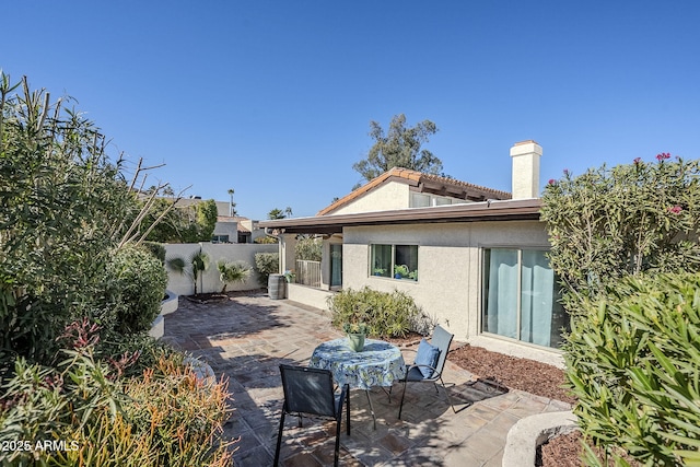 back of house with a patio