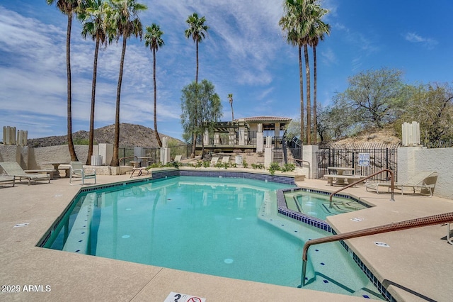 view of pool featuring a pergola, a patio area, and a community hot tub