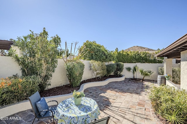 view of patio with central AC unit and a mountain view