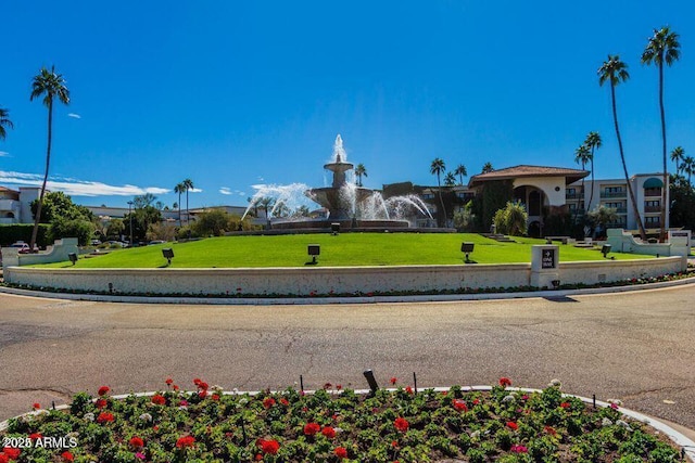 view of property's community with a lawn