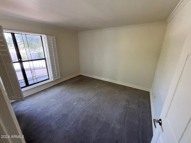 empty room with dark carpet and ornamental molding