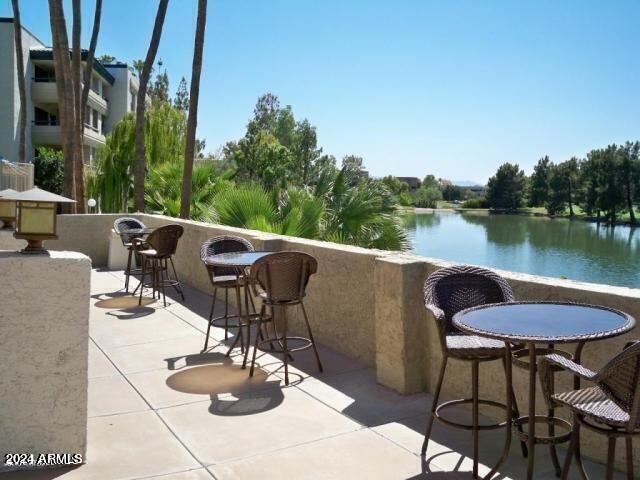 balcony featuring a water view and a patio