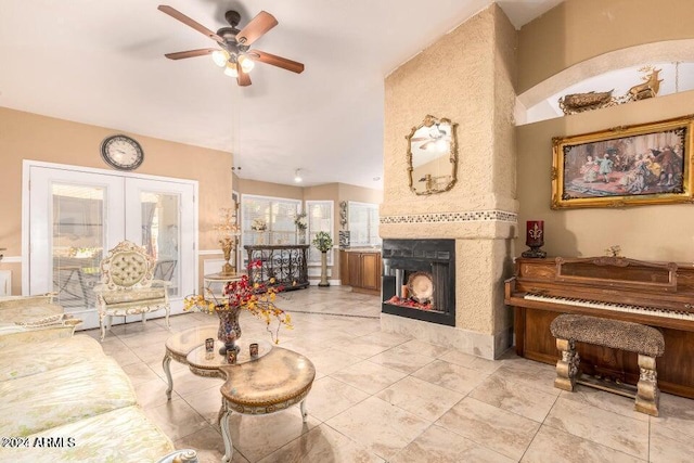 living room featuring ceiling fan, a healthy amount of sunlight, and a multi sided fireplace