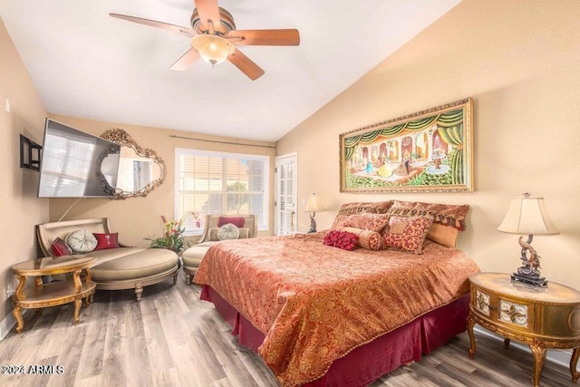 bedroom featuring hardwood / wood-style floors, ceiling fan, and vaulted ceiling