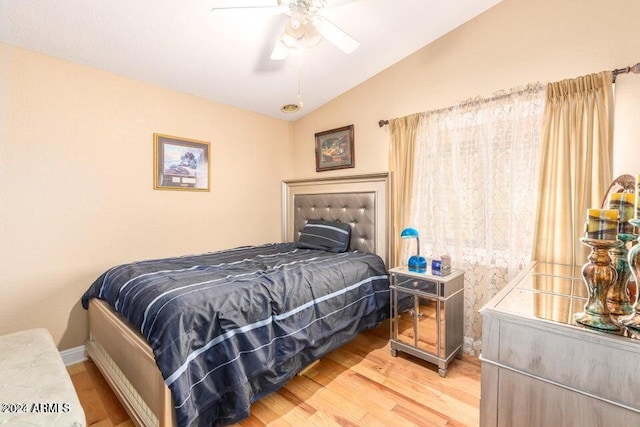 bedroom featuring ceiling fan, lofted ceiling, and hardwood / wood-style flooring