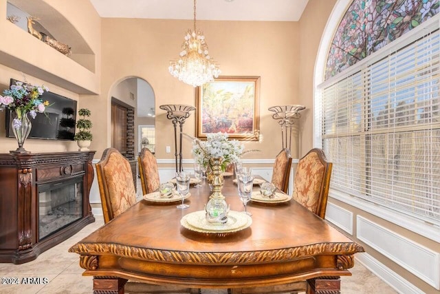 dining space with light tile patterned flooring and a chandelier