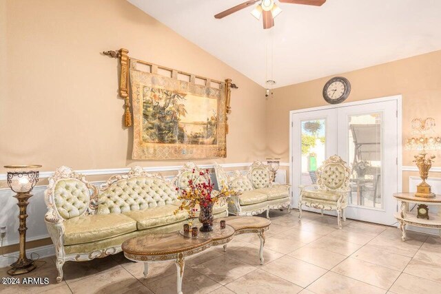 living area with ceiling fan, french doors, light tile patterned floors, and vaulted ceiling