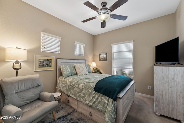 carpeted bedroom featuring ceiling fan and baseboards