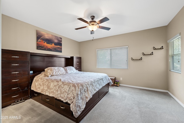 bedroom featuring light carpet, ceiling fan, and baseboards