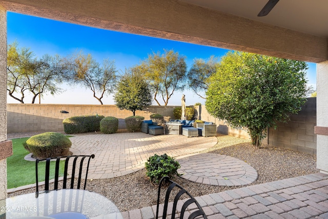 view of patio / terrace with ceiling fan, a fenced backyard, and an outdoor living space