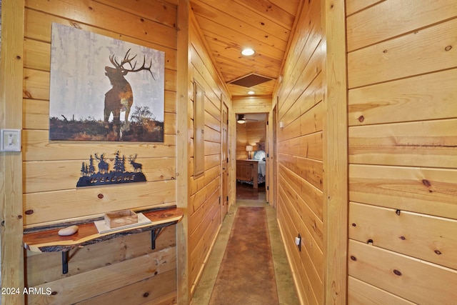 hallway featuring wooden walls