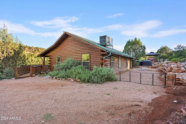 view of side of property featuring central AC and a wooden deck