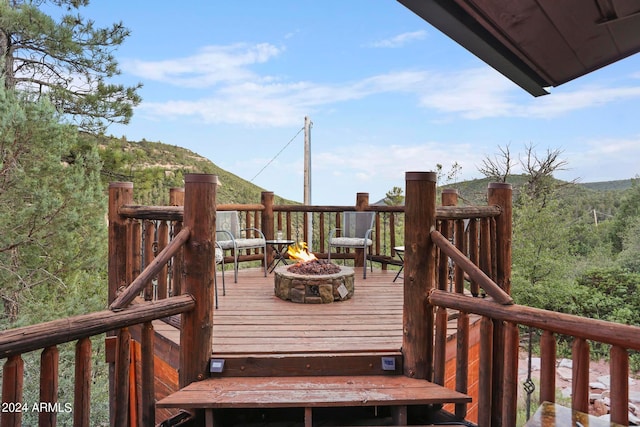 wooden deck with an outdoor fire pit