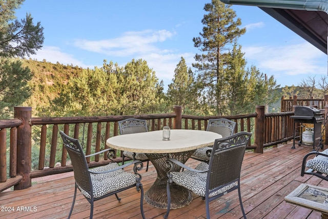 wooden terrace featuring a grill