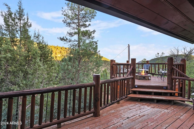 wooden deck featuring a fire pit