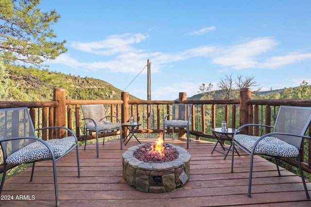 wooden terrace featuring an outdoor fire pit