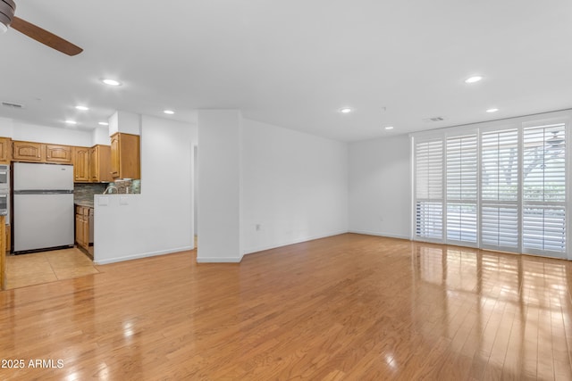 4200 N Miller Rd Unit 112, Scottsdale, AZ 85251 - unfurnished living room with recessed lighting, a ceiling fan, light wood-type flooring, and baseboards