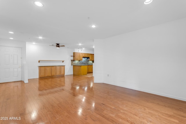 4200 N Miller Rd Unit 112, Scottsdale, AZ 85251 - unfurnished living room with recessed lighting, ceiling fan, light wood finished floors, and baseboards