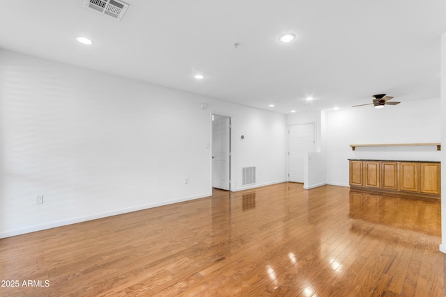 4200 N Miller Rd Unit 112, Scottsdale, AZ 85251 - unfurnished living room with light wood-type flooring, recessed lighting, a ceiling fan, and baseboards