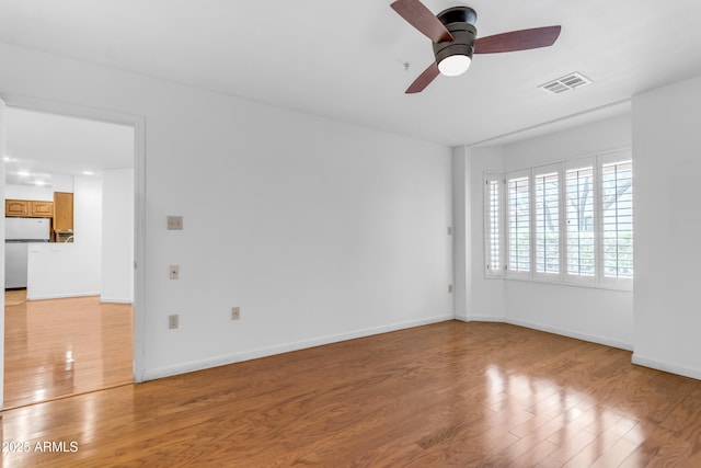 4200 N Miller Rd Unit 112, Scottsdale, AZ 85251 - unfurnished room featuring light wood finished floors, a ceiling fan, and baseboards