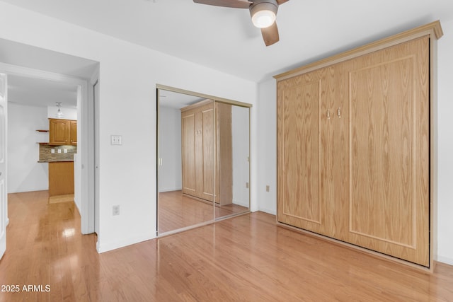 4200 N Miller Rd Unit 112, Scottsdale, AZ 85251 - unfurnished bedroom featuring wood finished floors, a closet, and ceiling fan