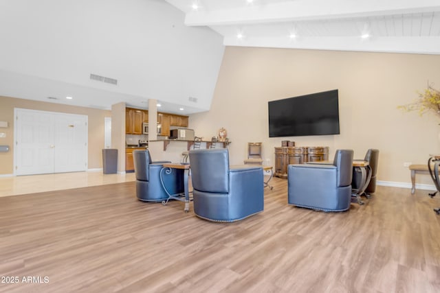 4200 N Miller Rd Unit 112, Scottsdale, AZ 85251 - living area featuring light wood-type flooring, high vaulted ceiling, baseboards, and beam ceiling
