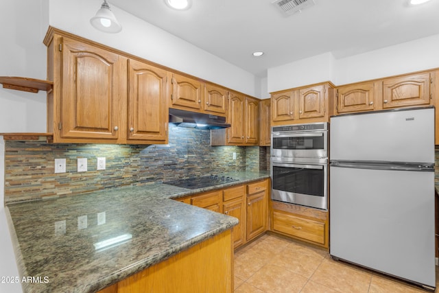 4200 N Miller Rd Unit 112, Scottsdale, AZ 85251 - kitchen with appliances with stainless steel finishes, under cabinet range hood, light tile patterned floors, tasteful backsplash, and brown cabinets