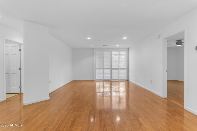 4200 N Miller Rd Unit 112, Scottsdale, AZ 85251 - empty room featuring light wood finished floors, recessed lighting, and baseboards
