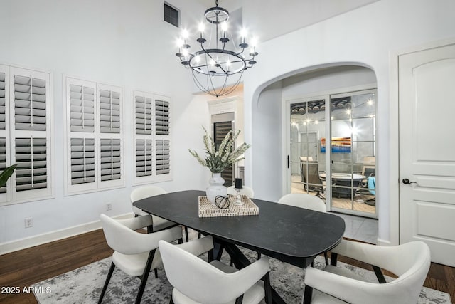 dining area with a notable chandelier and hardwood / wood-style flooring