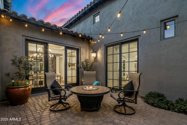 patio terrace at dusk with an outdoor fire pit