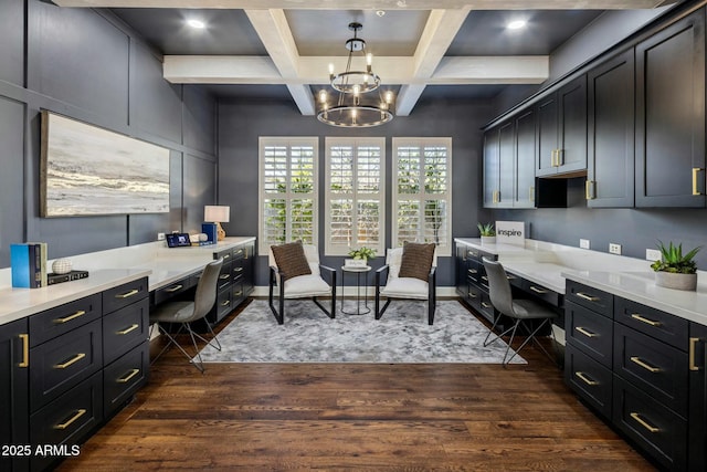 office featuring dark hardwood / wood-style flooring, built in desk, and a chandelier