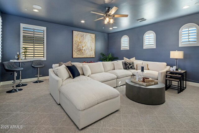 living room with light carpet and ceiling fan