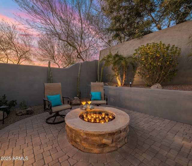 patio terrace at dusk with a fire pit