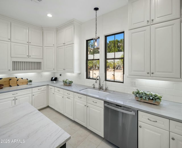 kitchen with dishwasher, white cabinets, light stone counters, and decorative light fixtures