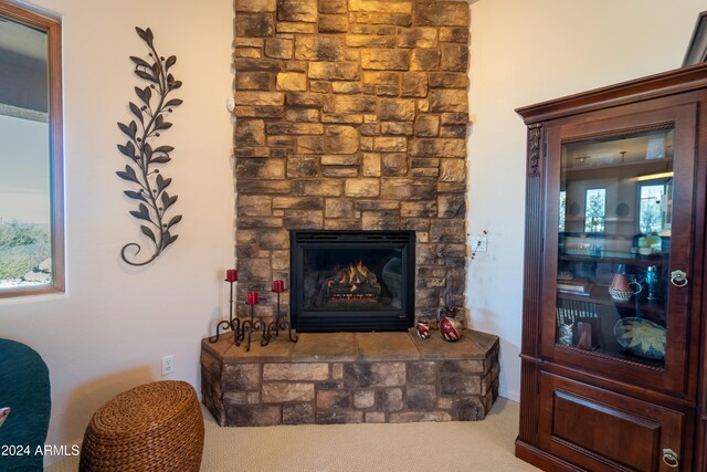 interior space featuring carpet and a stone fireplace