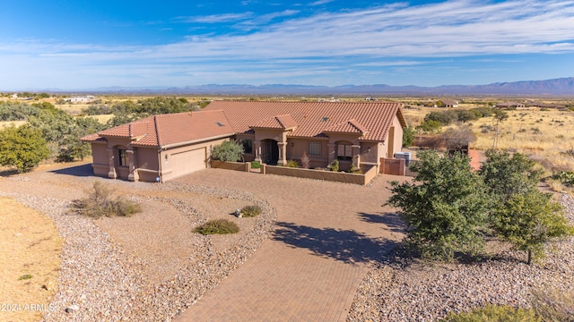 view of front of property with a mountain view and a garage