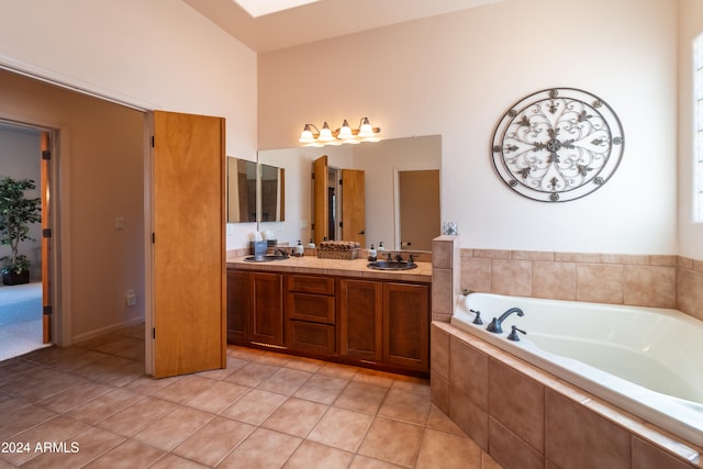 bathroom with vanity, tiled bath, and tile patterned floors