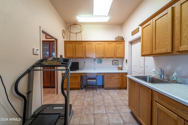 kitchen featuring light tile patterned floors and sink