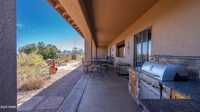 view of patio featuring an outdoor kitchen and area for grilling