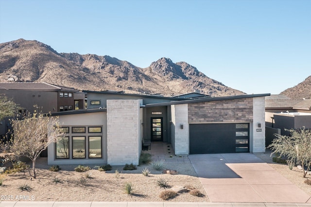 view of front of property featuring a mountain view and a garage