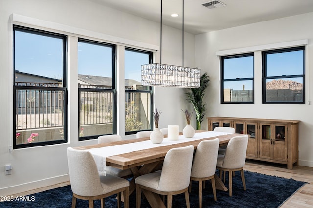 dining area with an inviting chandelier and wood-type flooring