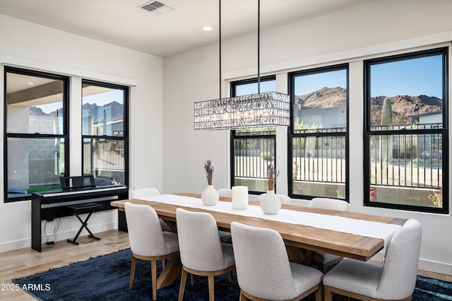 dining area with a mountain view and hardwood / wood-style flooring