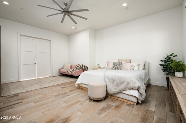 bedroom with hardwood / wood-style flooring and ceiling fan