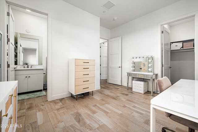 bathroom with hardwood / wood-style flooring and vanity