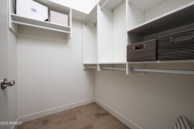 walk in closet featuring light hardwood / wood-style flooring