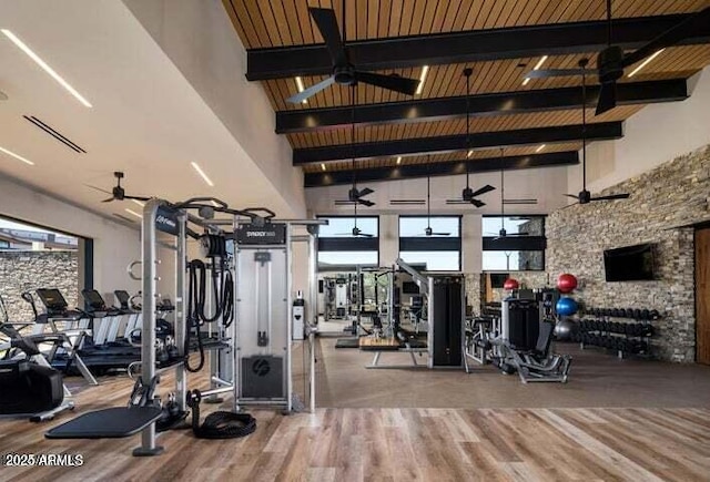 gym featuring hardwood / wood-style flooring, ceiling fan, high vaulted ceiling, and wooden ceiling